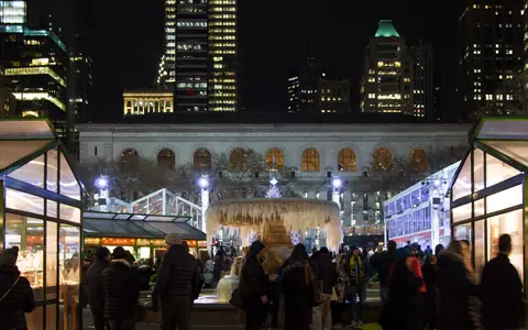 Holiday market stalls at Bryant Park Winter Village at night