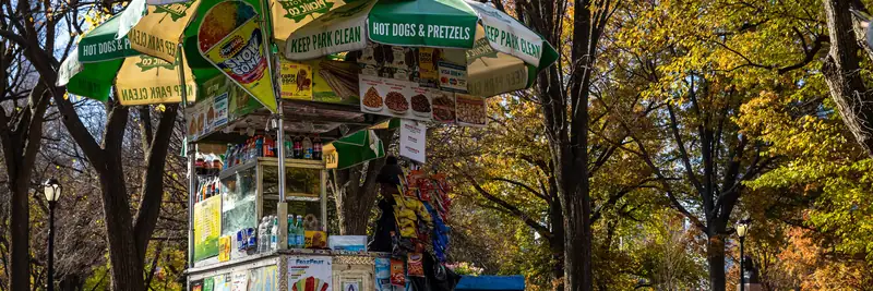 A food cart under autumn trees in Central Park