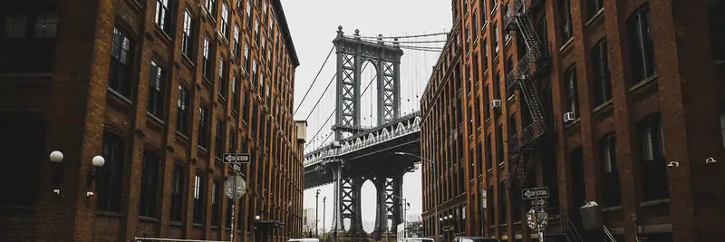 The Manhattan Bridge framed by brick warehouses on Washington Street in Dumbo, Brooklyn