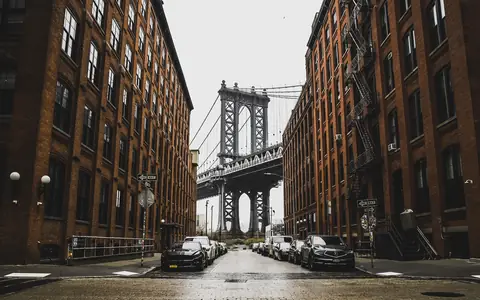 The Manhattan Bridge framed by brick warehouses on Washington Street in Dumbo, Brooklyn